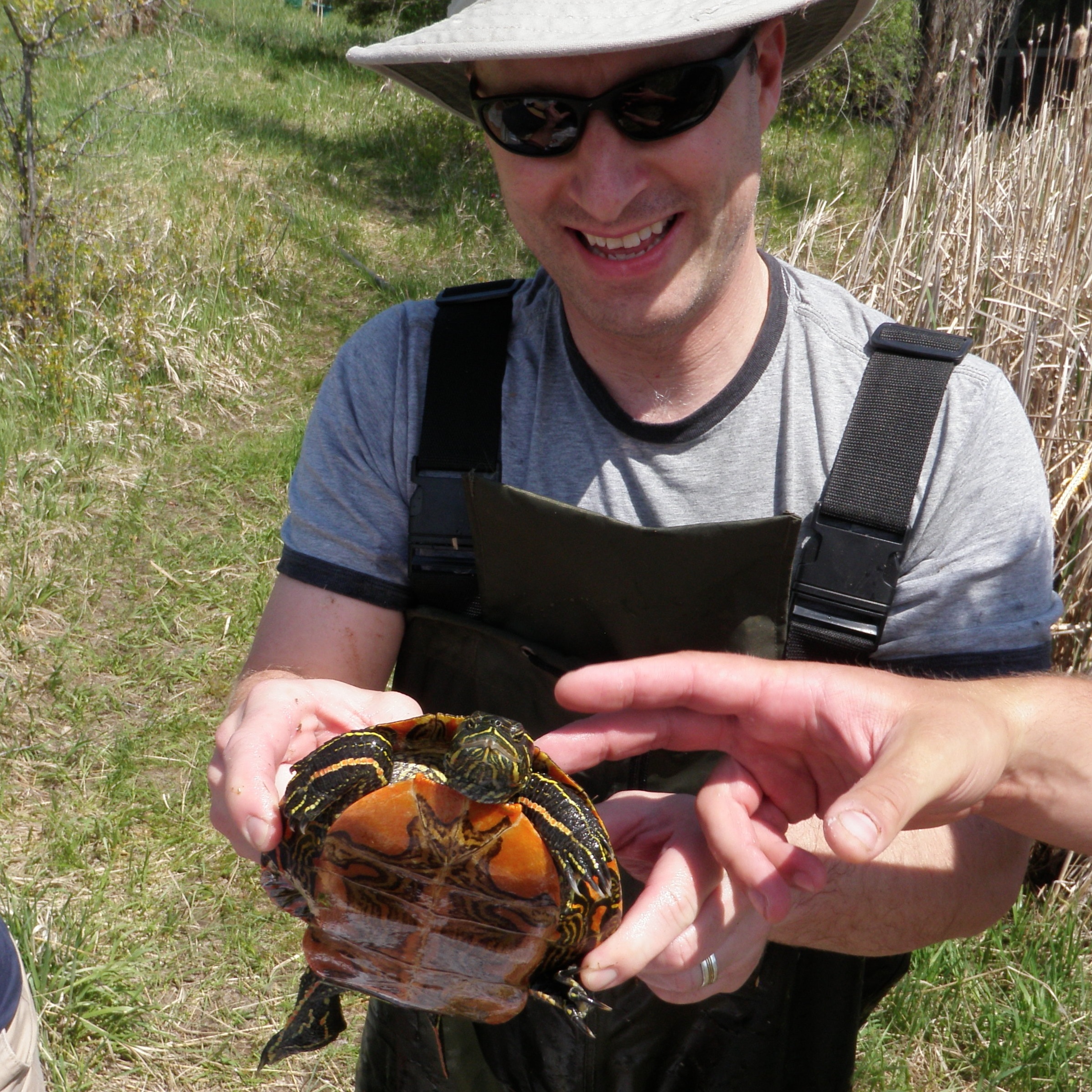 Jesse showing off a turtle at a local pond.